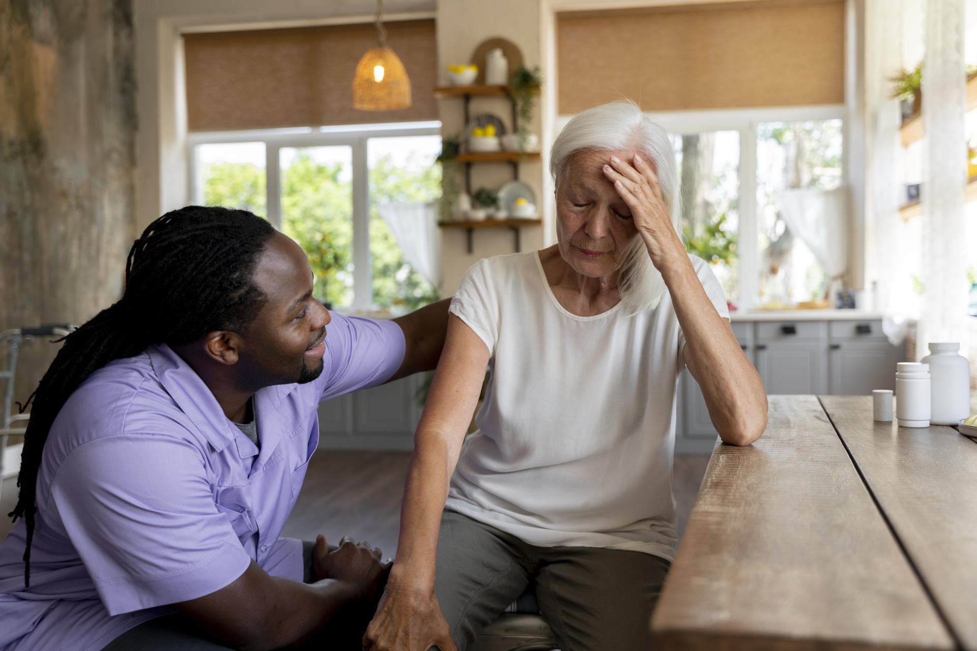 A home carer making sure one of his elderly clients is ok after receiving a care alert.