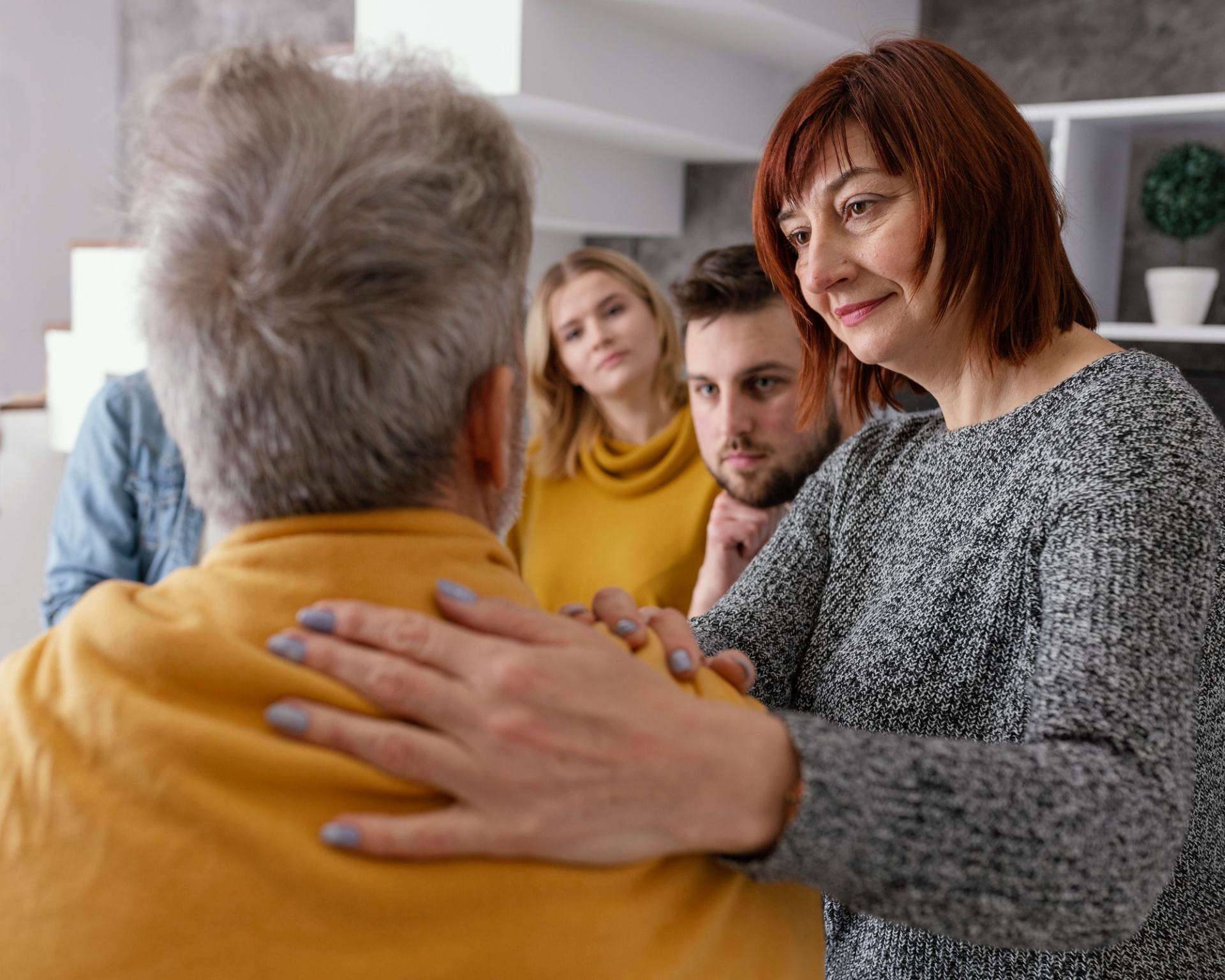 A family reassuring their elderly relative.