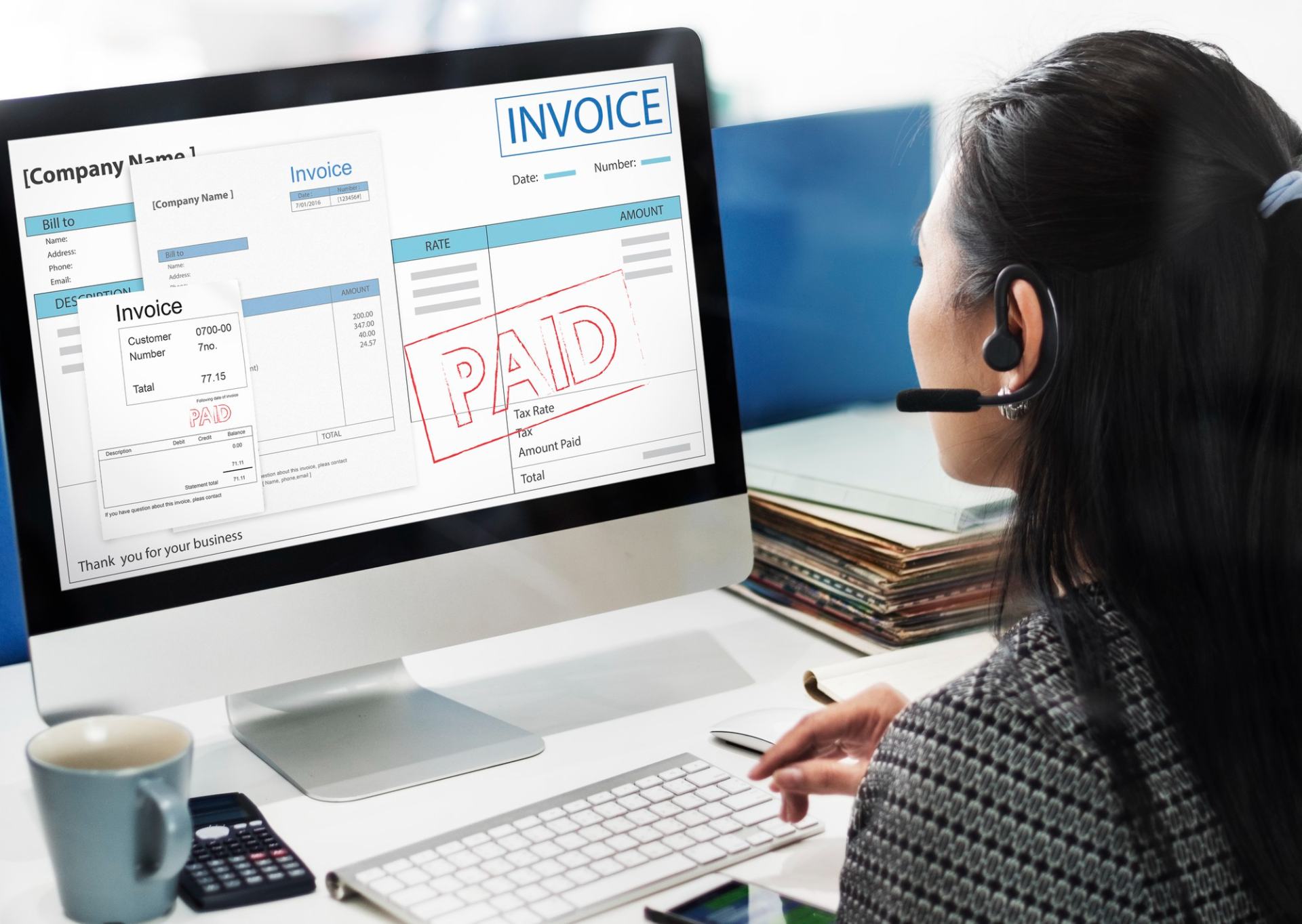 A UK home care agency owner using automation for her invoicing. Her laptop has an invoice on-screen with Paid stamped across it. A UK home care agency owner using automation for her invoicing. Her laptop has an invoice on-screen with Paid stamped across it.